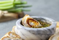 Fiery Sheet Pan Chicken Potstickers with Zesty Ginger Dipping Sauce