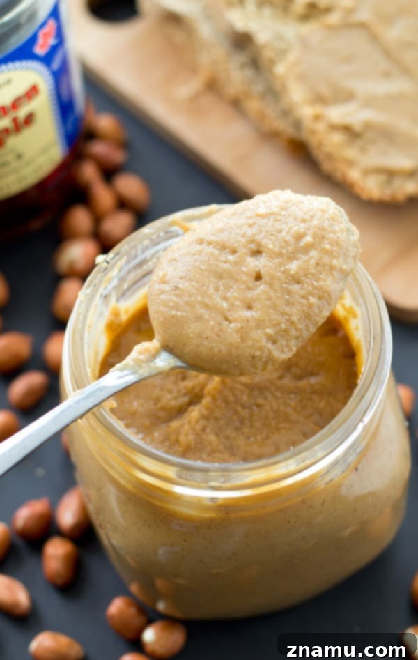 Maple Vanilla Peanut Butter Perfection 4 Peanuts being processed into smooth butter in a food processor bowl.