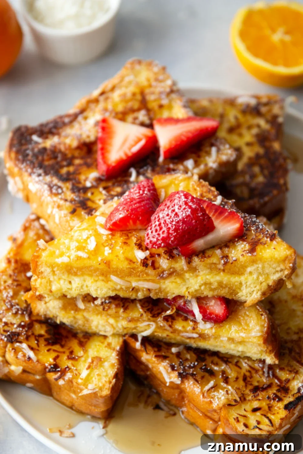 Tropical Coconut French Toast 6 Platter of Coconut Stuffed French Toast with strawberries and maple syrup