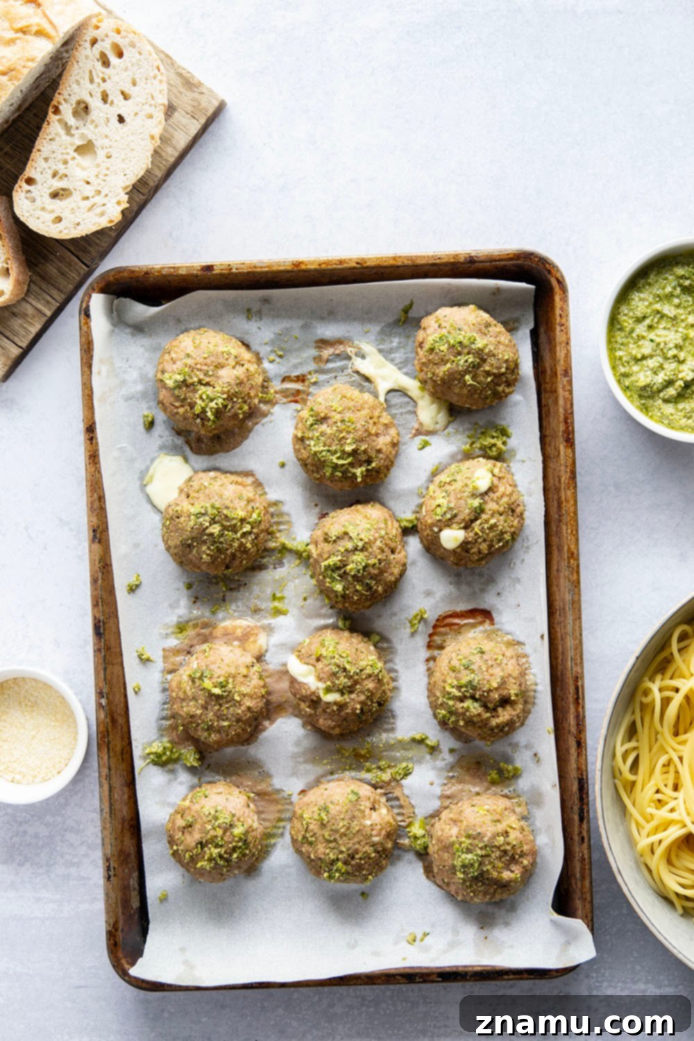 Melted Mozzarella Pesto Turkey Meatballs 4 Ingredients for pesto turkey meatballs laid out, including ground turkey, pesto, mozzarella, and panko.