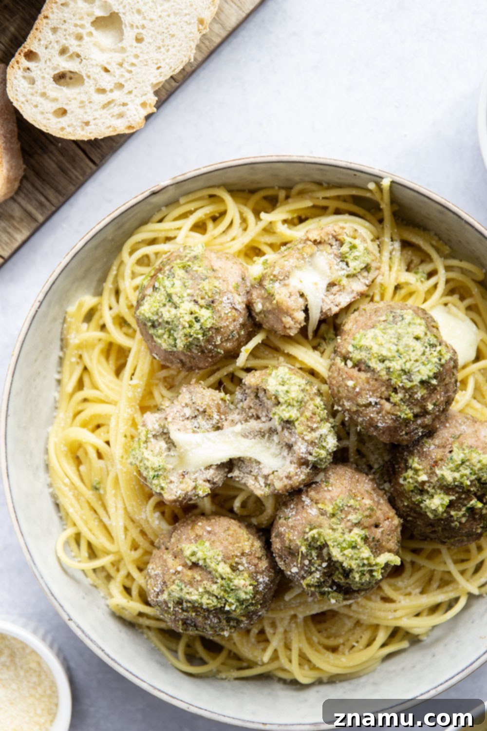 Melted Mozzarella Pesto Turkey Meatballs 5 A bowl of fresh green basil pesto, ready to be used in turkey meatballs.