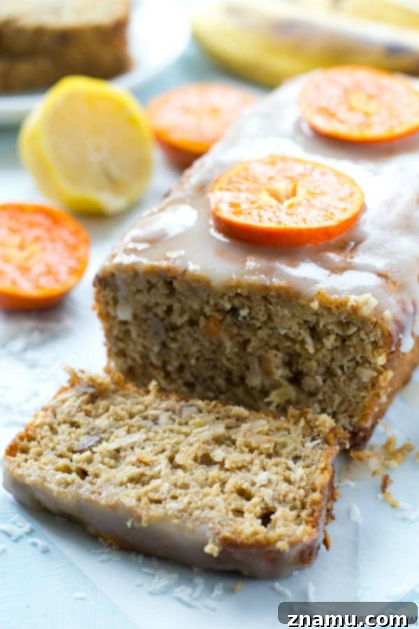 Sunshine Banana Loaf with Tangy Citrus 3 A close-up of a slice of the moist Tropical Banana Bread, showing the pineapple and coconut pieces. @WholeHeavenly