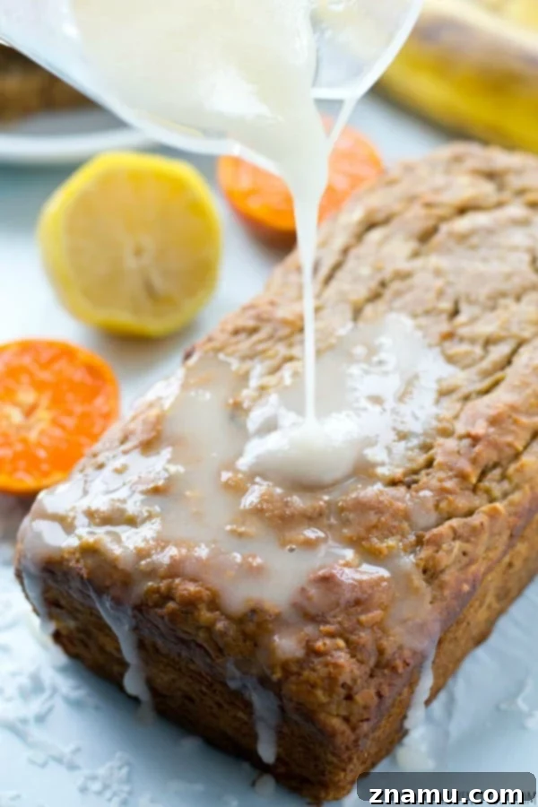 Sunshine Banana Loaf with Tangy Citrus 7 A perfectly sliced piece of Tropical Banana Bread, showcasing its moist crumb and tropical goodness. @WholeHeavenly