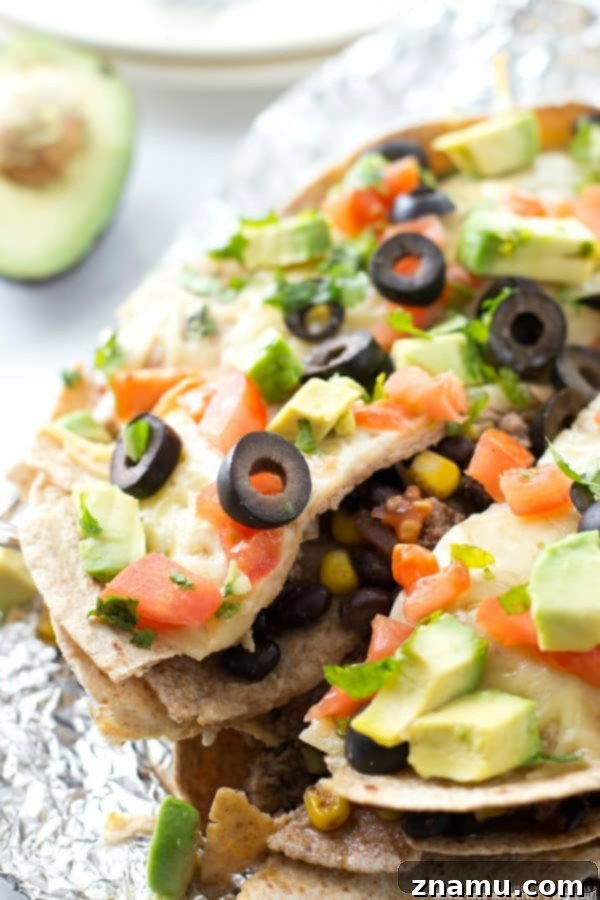 Slow Cooker Enchilada Bake 4 A slice of hearty crockpot enchilada pie served on a plate, garnished with fresh cilantro