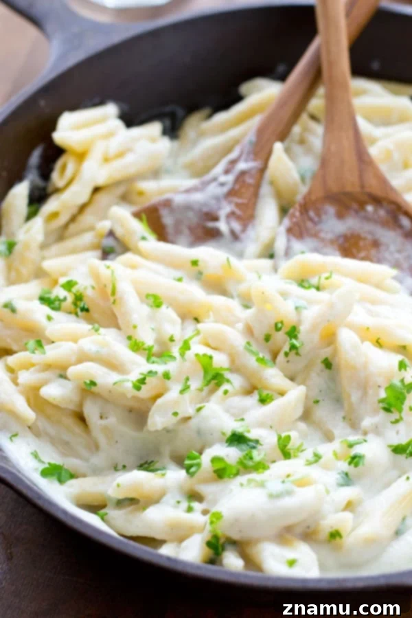 Quick Creamy Cauliflower Pasta Alfredo 5 A generous serving of lightened-up Alfredo pasta, highlighting the creamy sauce coating every noodle. @WholeHeavenly