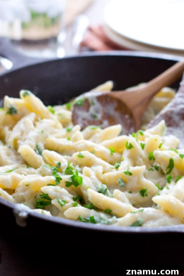 Quick Creamy Cauliflower Pasta Alfredo 6 A bowl of creamy cauliflower Alfredo pasta, perfect for a comforting and healthy meal. @WholeHeavenly