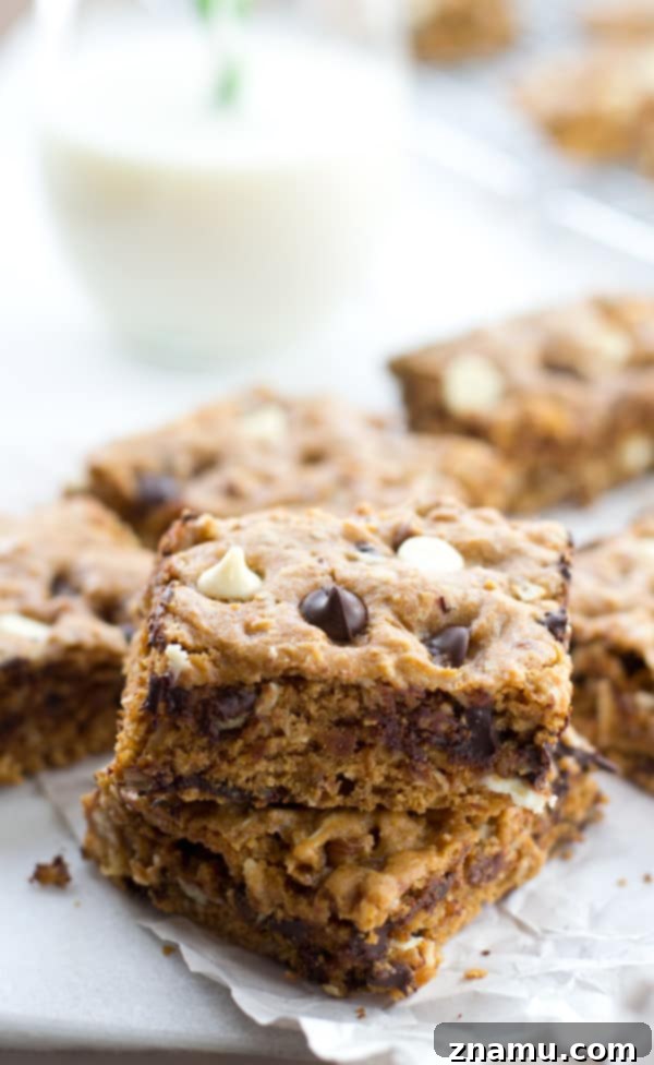 Irresistibly Soft Chewy Blondies 7 A glorious cross-section of a chewy blondie, revealing the gooey center and the abundance of chocolate, nuts, and coconut.