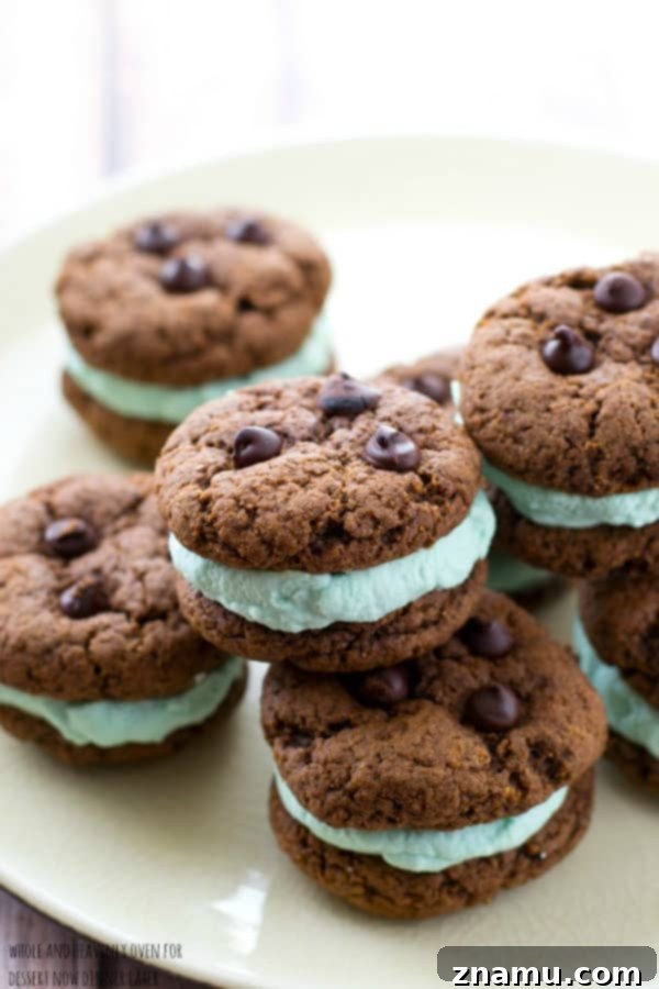 Creamy Chocolate Mint Cookie Sandwiches 5 An overhead shot of several Double Chocolate Mint Cream Sandwich Cookies, arranged artfully on a plate for serving.