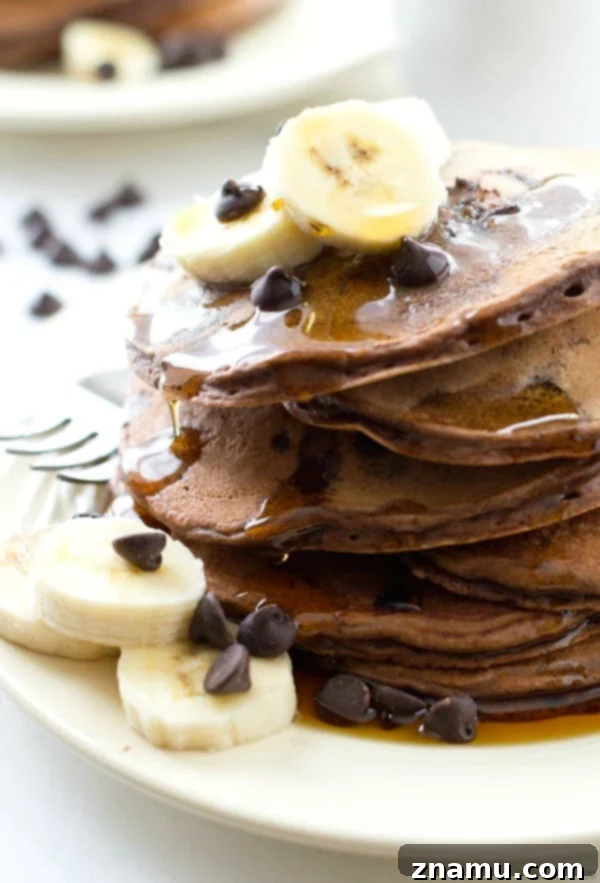 Decadent Double Chocolate Banana Pancakes 2 Thick, fluffy Double Chocolate Banana Pancakes, loaded with rich banana flavor and a double delight of chocolate chips, ready to impress your family.