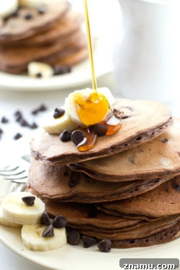 Decadent Double Chocolate Banana Pancakes 3 A mouth-watering stack of Double Chocolate Banana Pancakes, showcasing their incredible thickness and fluffy texture, perfect for a special breakfast.