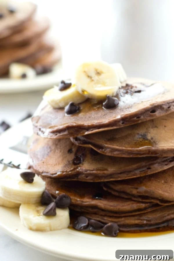 Decadent Double Chocolate Banana Pancakes 6 An enticing close-up of Double Chocolate Banana Pancakes, showcasing the rich texture and delicious chocolate swirls before being fully topped.