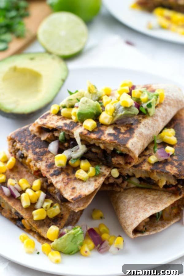 Close-up of golden-brown Beef and Bean Quesadillas, filled with melted cheese and savory ingredients