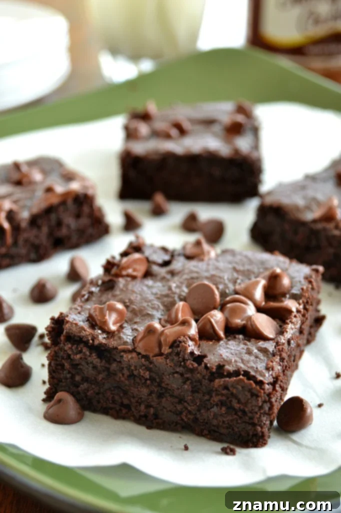 Rich, dark Ultimate Gluten-Free Fudge Brownies stacked on a plate