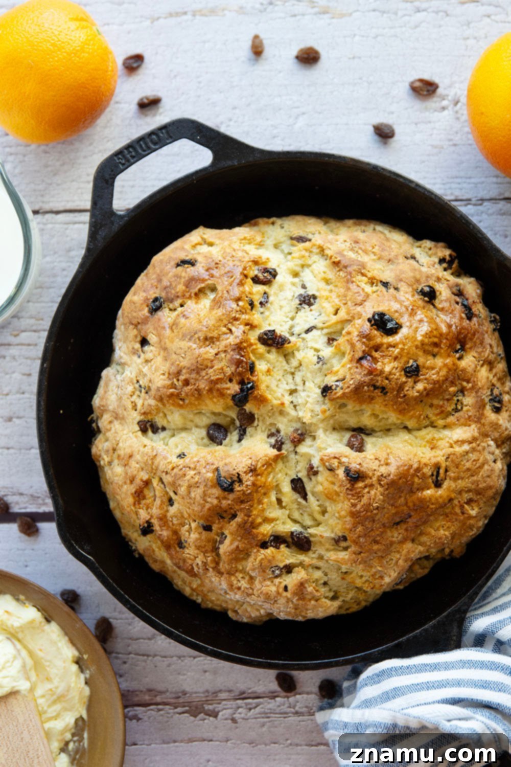 Sunshine Orange Irish Soda Bread with Cream Cheese 5 Freshly baked Irish soda bread loaf, with the traditional cross cut on top, resting on a wire rack.