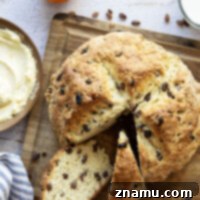 This hearty Irish soda bread is perfectly soft and tender inside and studded with of sweet raisins. Enjoy slices warm from the oven with a tangy orange cream cheese.