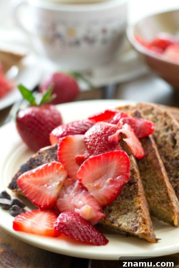 Mocha French Toast with Sun-Kissed Strawberry Compote 6 A stack of golden brown Mocha French Toast topped with berries