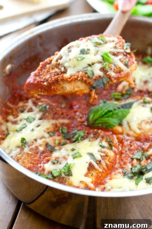 30-Minute One-Pan Chicken Parmesan 5 A close-up shot showcasing the golden-brown, crispy texture of the breaded chicken, perfectly complemented by the vibrant red tomato sauce.