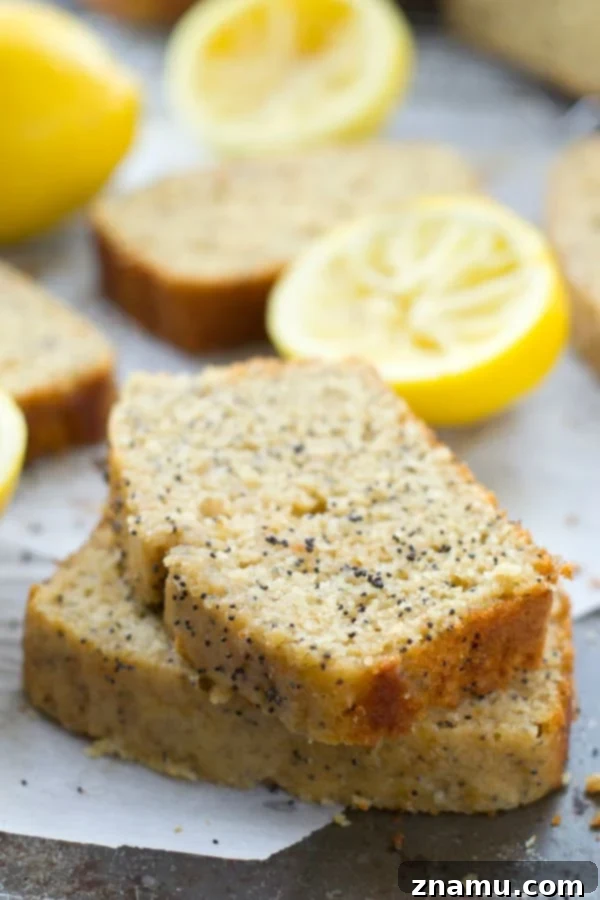 Zesty Poppy Drizzle Loaf 4 A large slice of Lemon Poppy Seed Bread with a generous amount of glaze, resting on a serving plate.