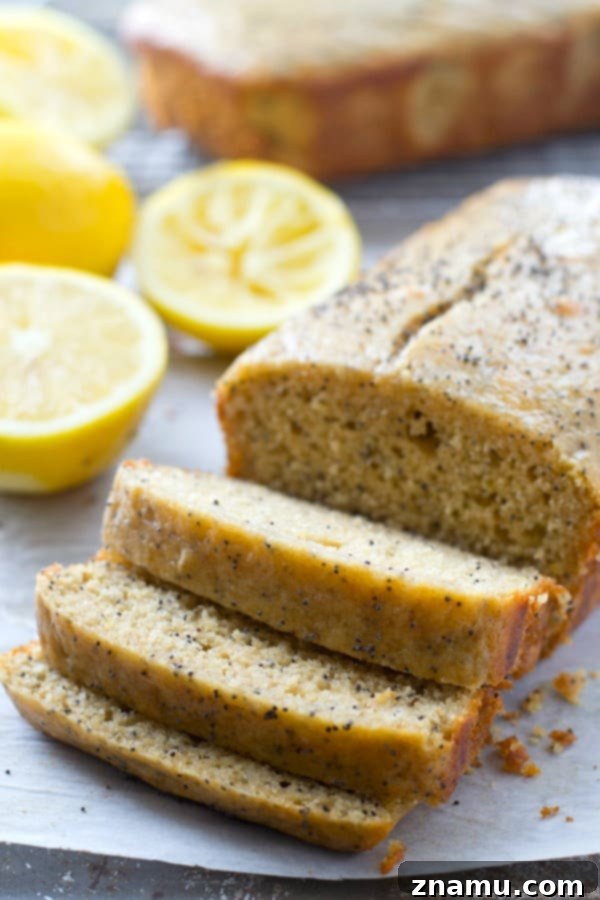 Zesty Poppy Drizzle Loaf 6 Multiple slices of Glazed Lemon Poppy Seed Bread arranged on a plate, ready to be served.