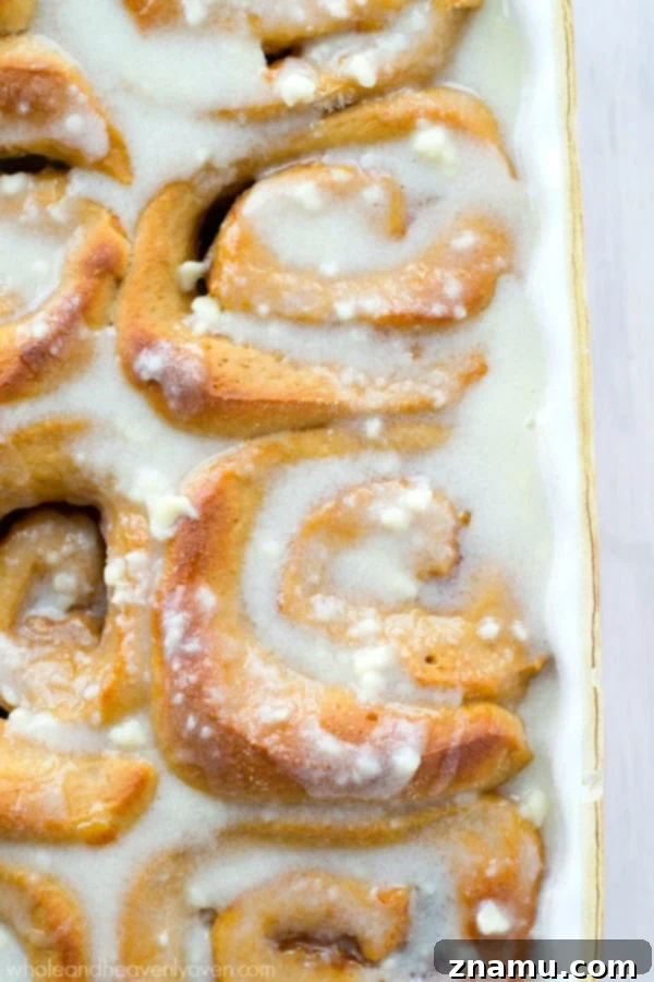 Perfectly Swirled Orange Cinnamon Rolls Close-up of freshly baked orange cinnamon rolls, showcasing the beautiful swirl of orange marmalade and cinnamon sugar.
