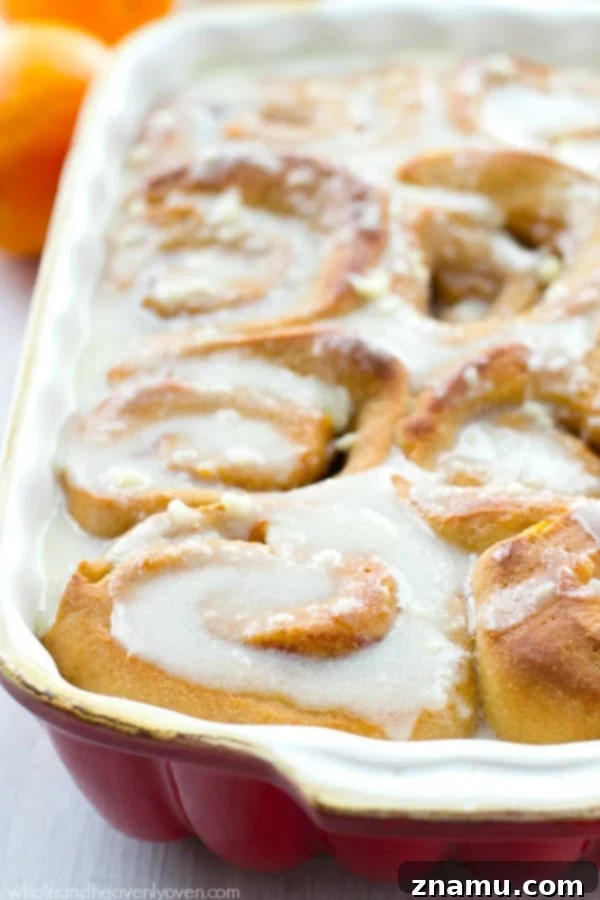 Warm Orange Cinnamon Rolls Before Icing A tray of golden-brown orange cinnamon rolls, fresh from the oven, awaiting their generous topping of cream cheese icing.