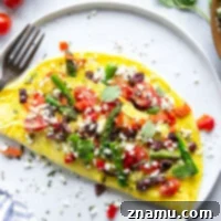 Loaded with tender asparagus, juicy cherry tomatoes and lots of feta, this Greek omelet whips up in minutes and is packed full of fresh ingredients!