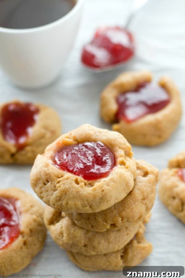 Buttery Shortbread Jam Impressions 4 A tray of warm jam shortbread thumbprint cookies, ready to be transferred for cooling.