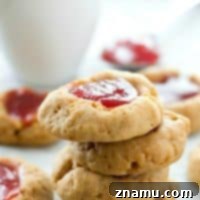 Buttery Shortbread Jam Impressions 9 Finished Jam Shortbread Thumbprint Cookies on a cooling rack.