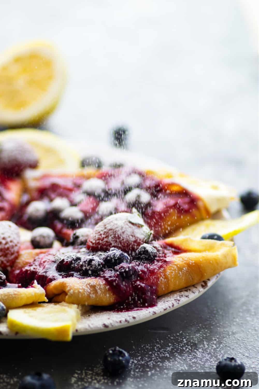 Berries & Cream Cheese Crepes 3 Close-up shot of beautiful, stacked mixed berry cream cheese crepes with fresh berries