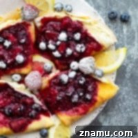 Mixed berry cream cheese crepes with fresh berries and powdered sugar