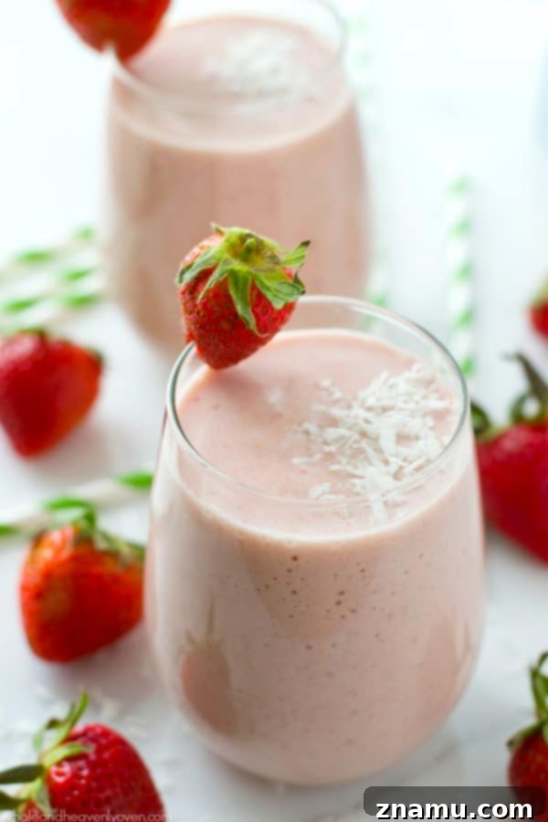 Another view of the Strawberry Piña Colada Protein Smoothie, showcasing its vibrant color.