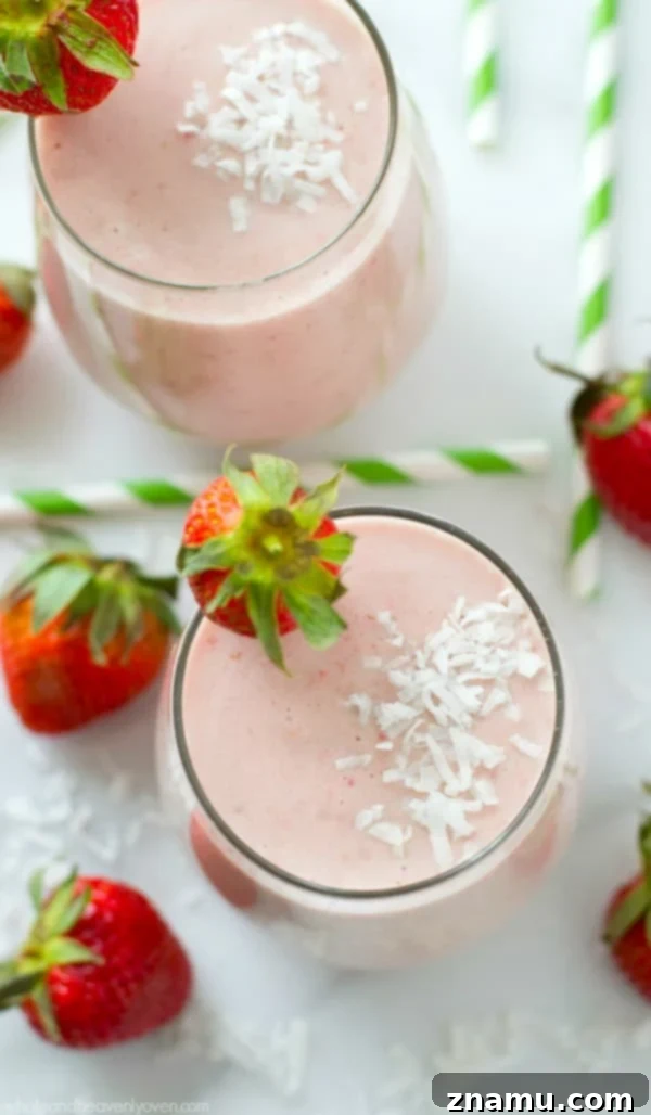 Full glass of Strawberry Piña Colada Protein Smoothie ready to be enjoyed.