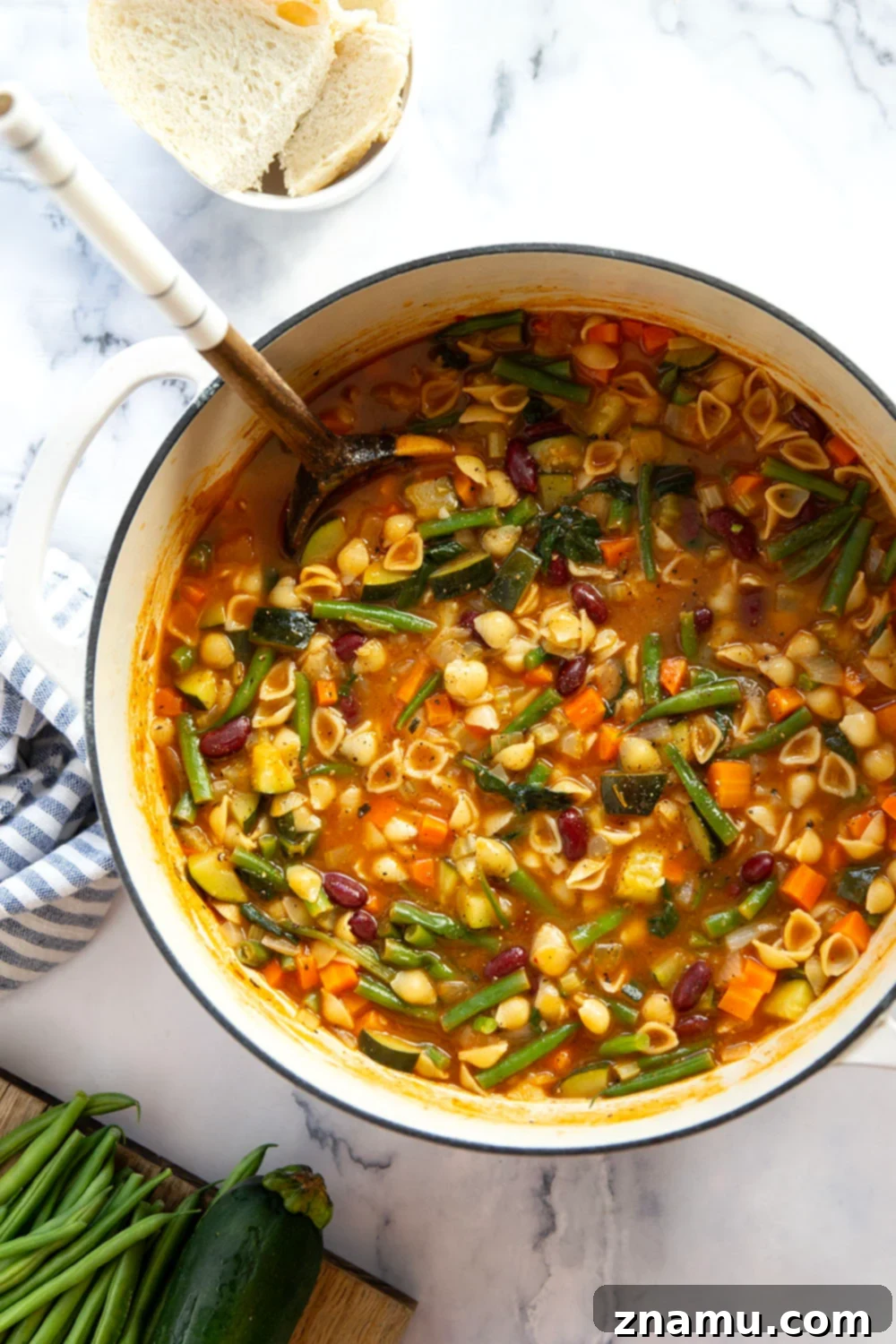 Hearty Vegetarian Minestrone 3 Close-up of a steaming bowl of vegetarian minestrone soup, showcasing the diverse vegetables and small pasta shapes.