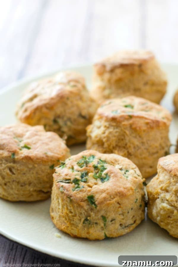 Artistically arranged Herbed Greek Yogurt Buttermilk Biscuits, highlighting their golden crust and fluffy texture.