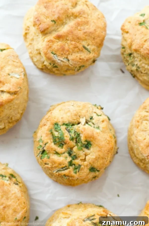 Close-up of freshly minced herbs like chives, rosemary, and parsley, ready to be incorporated into the biscuit dough.