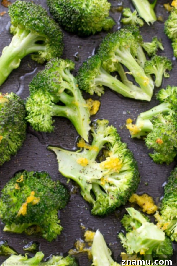 Crispy Lemon Roasted Broccoli and a Cookbook Giveaway 2 Bright green lemon-roasted broccoli florets on a baking sheet, fresh and ready to eat.
