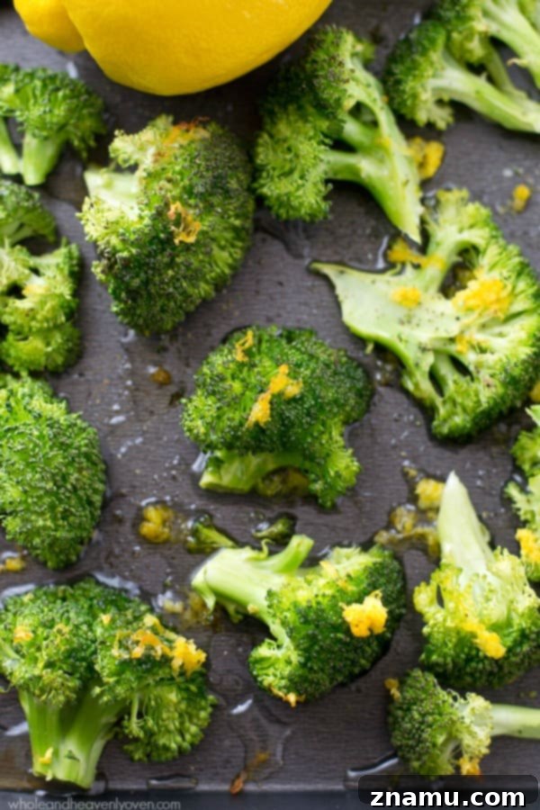 Crispy Lemon Roasted Broccoli and a Cookbook Giveaway 5 A pan of perfectly roasted broccoli florets with lemon slices, ready to be served.