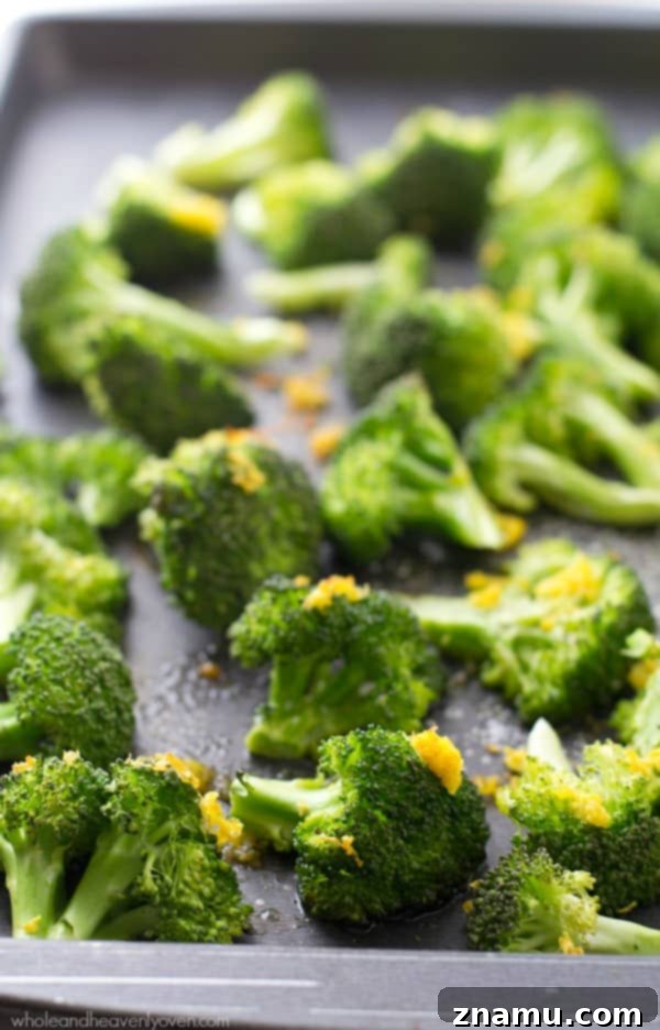 Crispy Lemon Roasted Broccoli and a Cookbook Giveaway 7 Several broccoli florets arranged artfully with a lemon slice, highlighting the fresh ingredients.
