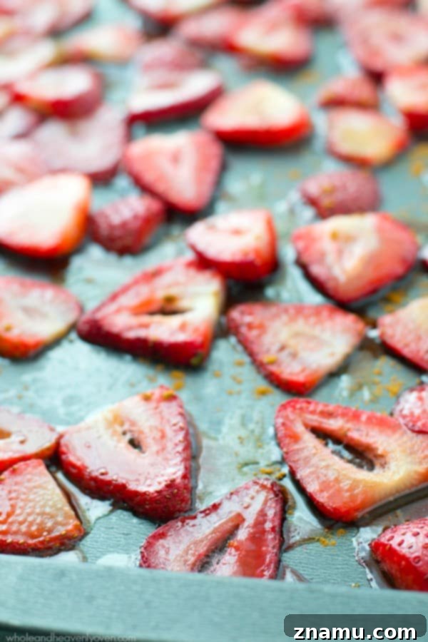 Zesty Orange Greek Yogurt Pancakes crowned with Roasted Strawberry Compote 7 Roasted strawberry sauce being generously poured over a stack of orange Greek yogurt pancakes, creating a mouth-watering visual.