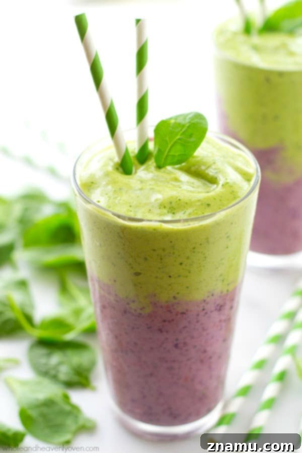 Vibrant Berry Green Energy Swirl 5 Close-up of a glass of layered mixed berry and green power smoothie with a fresh berry garnish