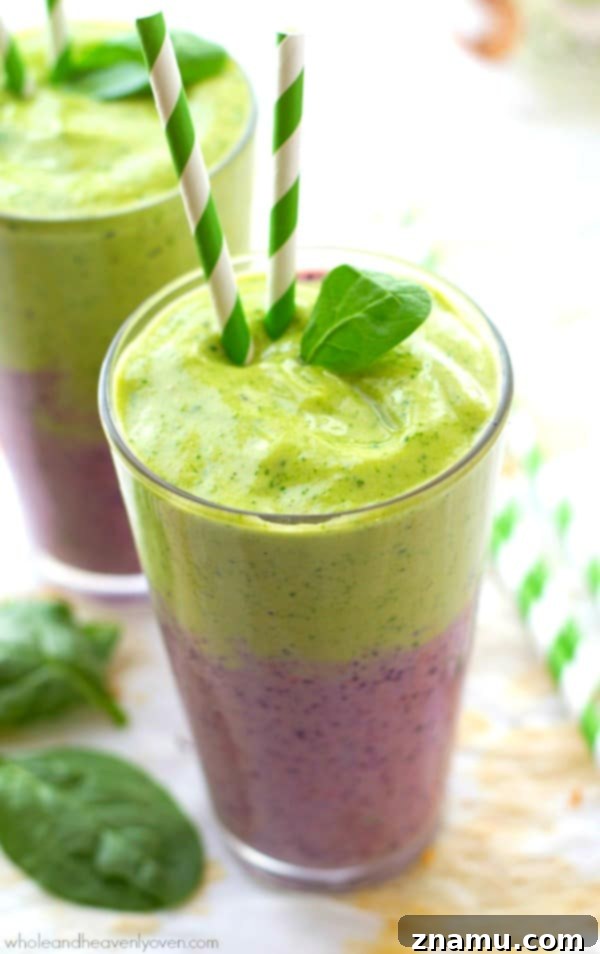 Vibrant Berry Green Energy Swirl 6 Multiple glasses of layered mixed berry and green power smoothies on a wooden surface