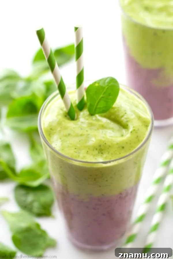 Vibrant Berry Green Energy Swirl 7 Side view of a glass with a beautifully layered berry and green power smoothie