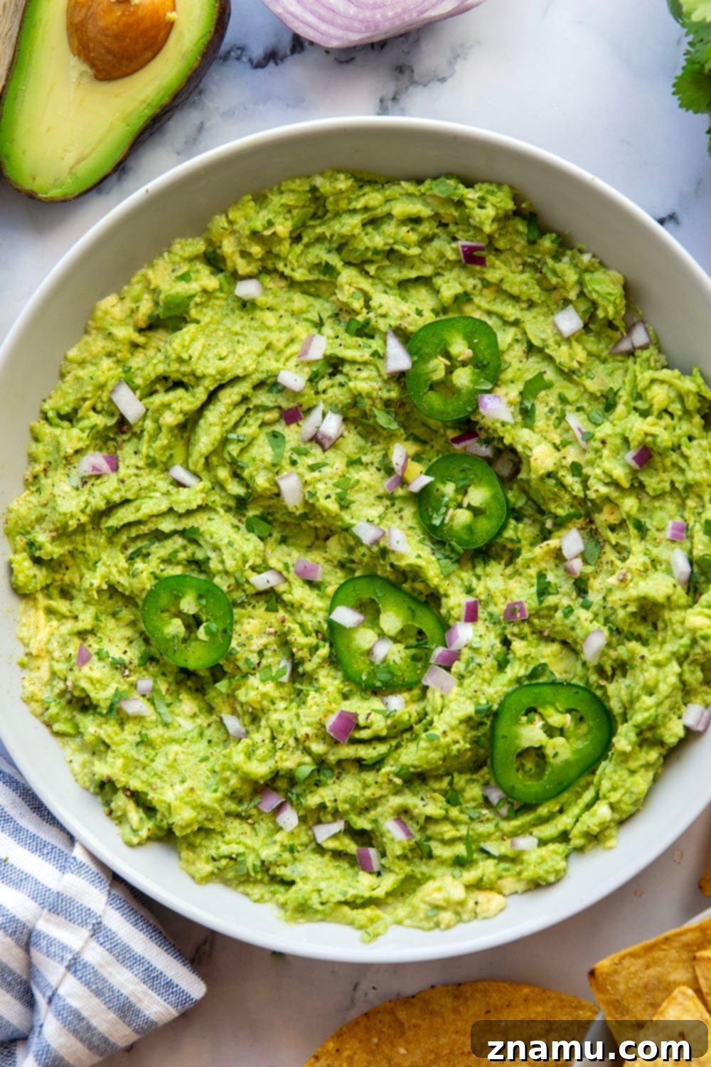 The Ultimate Guacamole Recipe 4 Freshly mashed avocado in a bowl, showing a creamy yet chunky texture, ready for other ingredients.