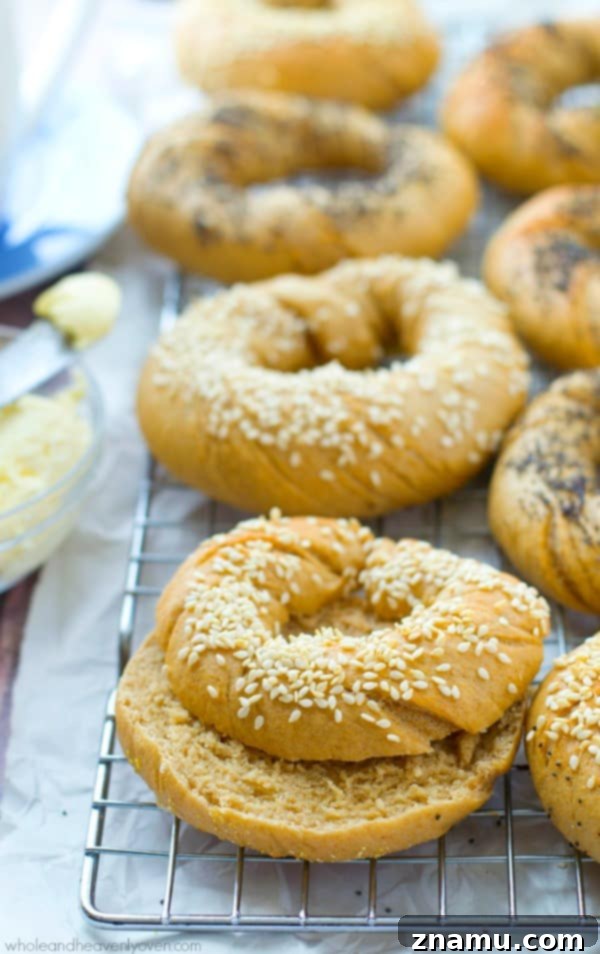 Authentic Homemade Deli Bagels 7 A delicious homemade bagel, perfectly toasted and spread with cream cheese, with a generous amount of seeds on top, ready for a delightful bite.
