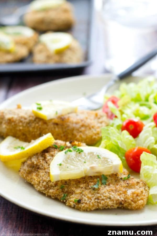 Irresistible Lemon-Garlic Crusted Chicken Tenders 4 A plate of golden chicken tenders, perfectly crusted and glistening with a hint of lemon, ready to eat.