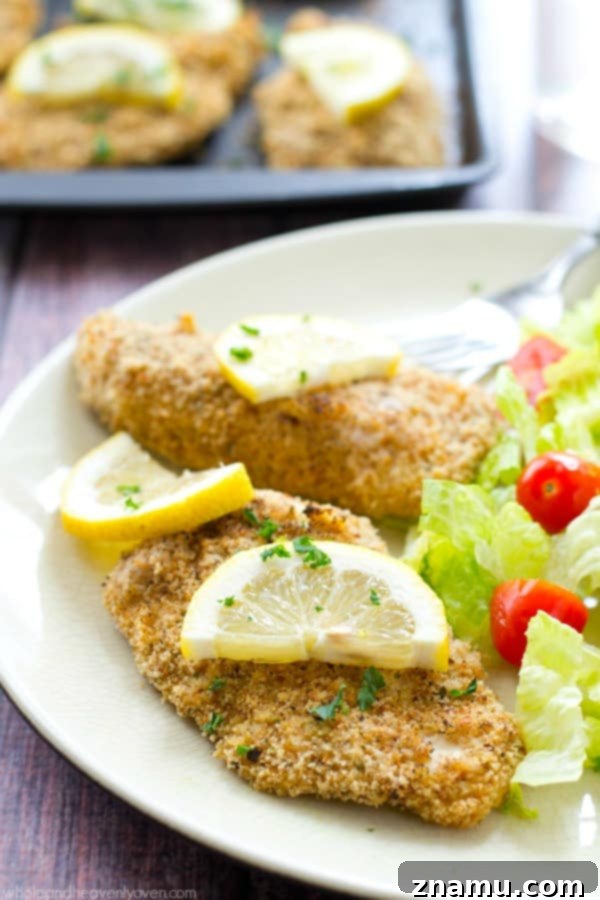 Irresistible Lemon-Garlic Crusted Chicken Tenders 6 Multiple servings of the crispy chicken tenders, garnished with fresh herbs, arranged artfully.