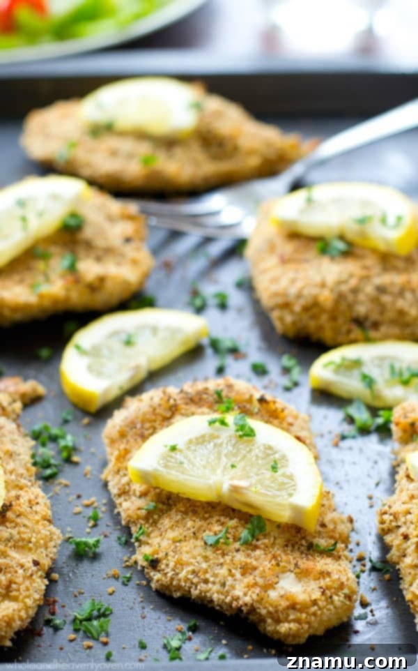 Irresistible Lemon-Garlic Crusted Chicken Tenders 8 Lemon and garlic are prominent in this photo, suggesting the key flavors of the chicken tenders.