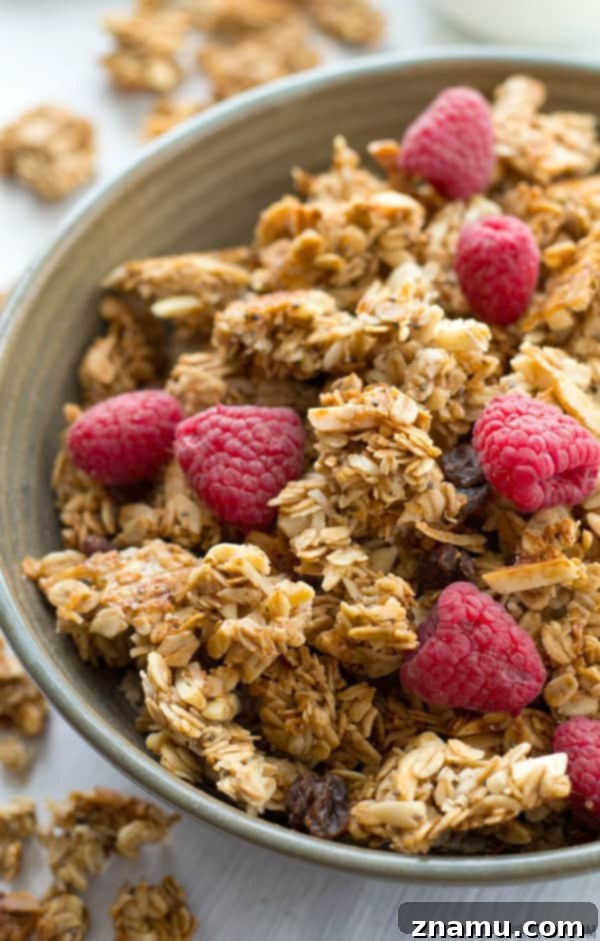 Learn all the secrets to making perfect large-cluster granola with this easy recipe! Perfectly huge and crunchy granola clusters with lots of almond flavor.