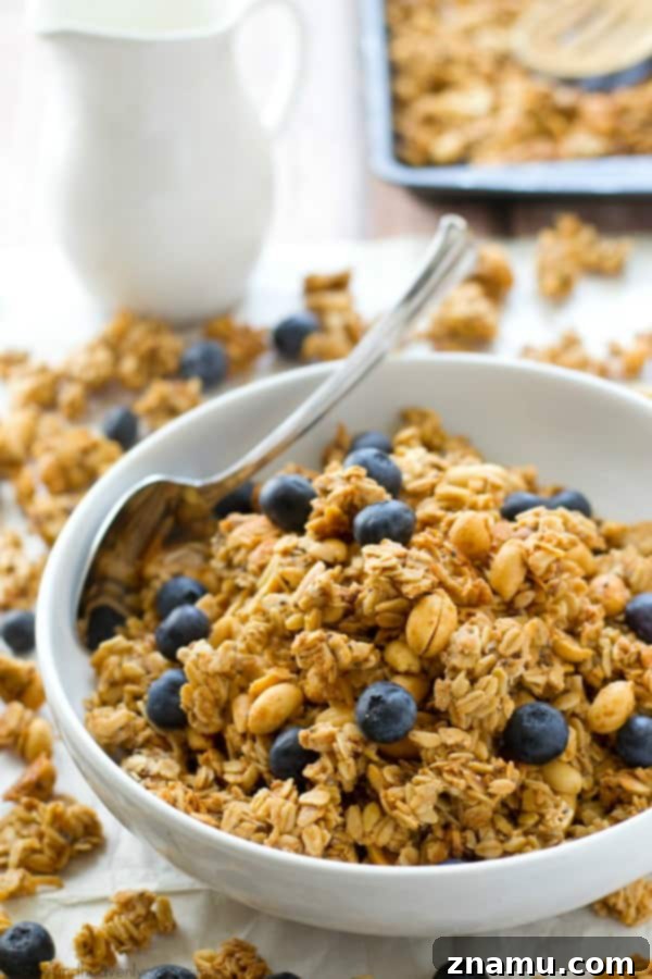 A closer view of the homemade peanut butter granola, emphasizing the large, satisfying clusters and golden-brown perfection. Perfect for breakfast. @WholeHeavenly