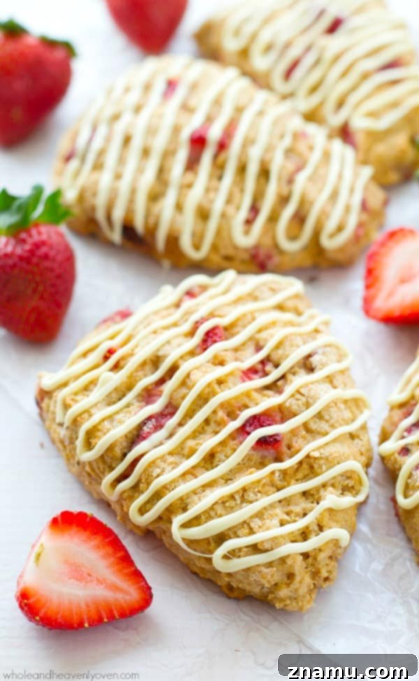 White Chocolate Strawberry Cream Scones 2 Flaky White Chocolate Strawberry Scones for Mother's Day brunch, adorned with a luscious white chocolate drizzle